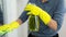 AI generated person wearing yellow gloves and cleaning floor