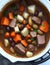 AI-Generated: Slow-Cooked Beef Stew with Carrots, Parsley, Olives, and Potatoes