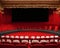 Ai generatedn empty theater with vibrant red seats and carpet