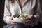 AI GENERATIVE, Healthy breakfast, Woman holds a bowl with a healthy breakfast of yogurt and fruit, with oat flakes