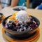 AI generative Patbingsu South Korean dessert made of shaved ice and condensed milk and sweet azuki bean paste topped with fresh