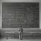 AI Generative photo of man at an enormous chalkboard writing lots of math