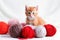 AI generative. Small red kitten is played with a ball of yarn