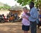 Aid relief volunteer emotional crying in face of poverty village Africa