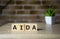 aida acronym of attention interest desire action business word on wooden cubes