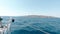 An Aigina Sailing Trip with a big yacht towards the greek island through a deep blue ocean strait during a sunny day in weekend. T