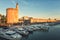 Aigues-Mortes, France - July 16, 2017: Sunset view of the harbor and ancient city wall with Tower of Constance