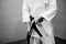 Aikido black belt on a white kimono.