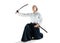 Aikido master practices defense posture. Healthy lifestyle and sports concept. Woman in white kimono on white background
