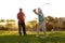 Aiming for the green. Two male golfers going through a round of golf.