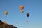 Air balloons festival in Cappadocia. Few hot air balloons against colorful vibrant sky