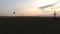 Air balloons flying over fields at dusk electric cables bellow industrialization