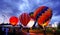 Air balloons glow with burner flame glowing in night at Nakhonr Ratchasima, Thailand