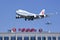 Air China Cargo Boeing 747-412BCF, B-2453 skims over China Aviation Oil Corp. building, Beijing, China