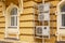 The air conditioners on the street hang on the wall of the house in the grille, protecting them from thieves