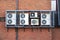 Air Conditioning condensers in cage hanging on wall