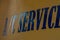 Air conditioning sign printed in bold reflective blue letters