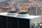 Air conditioning ventilators on roof with houses in background