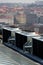 Air conditioning ventilators on roof with houses in background