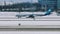 Air Dolomiti plane taxiing, snow on runway