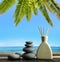 Air freshener with wooden aroma sticks and zen pebbles on the beach.