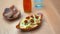 Air fried fries alongside dough balls, a glass and a bottle on a wooden table