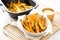 air fryer basket with golden sweet potato fries