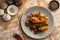 Air Fryer drummet chicken wing with garlic and pepper in a plate.