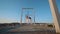 Air gymnastics woman hanging on aerial hoop on the roof with a nice view