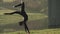 Air gymnastics woman performs acrobatics trick on aerial hoop. Flexible brunette