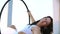 Air gymnastics woman performs acrobatics tricks on aerial hoop.