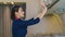 Air hostess checking luggage cabin compartment in airplane cabin