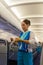 Air hostess flight attendant of the Bangkok airways is explain the usage safety equipment to the passengers on the plane and