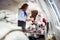 Air hostess Serving Cookies To Santa In Private Jet