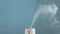 Air humidifier on a blue background. Steam humidification for health. Copy space for text
