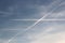 Air liner leaving a trace of exhaust gases glowing in the sun. Ecology of passenger traffic. Transport of goods by air. Intersect