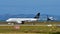 Air New Zealand A320 in Star Alliance livery taxis as another sister jet lands at Auckland International Airport