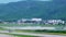 Air plane taking off from the airfield with the background of mountains and b