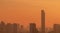 Air pollution. Smog and fine dust of pm2.5 covered city in the morning with orange sunrise sky. Cityscape with polluted air. Dirty