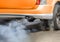 Air pollution from vehicle exhaust pipe on street
