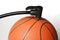 Air pump fills an orange basketball