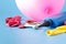 Air-pump inflating a pink ballon on a blue background