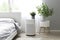 Air purifier in cozy white bedroom