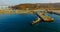 Air review of the coastline of the Russian island with a pier and ships