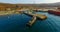 Air review of the coastline of the Russian island with a pier and ships