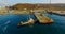 Air review of the coastline of the Russian island with a pier and ships