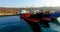 Air review of the coastline of the Russian island with a pier and ships