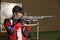 Air rifle shooter aiming. side view