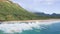 Air shot on Oahu Hawaii Island. Drone flies over Sandy Beach. View of the rocky mountains. Warm sunny day on a tropical