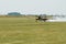 Air show plane landing on grass field